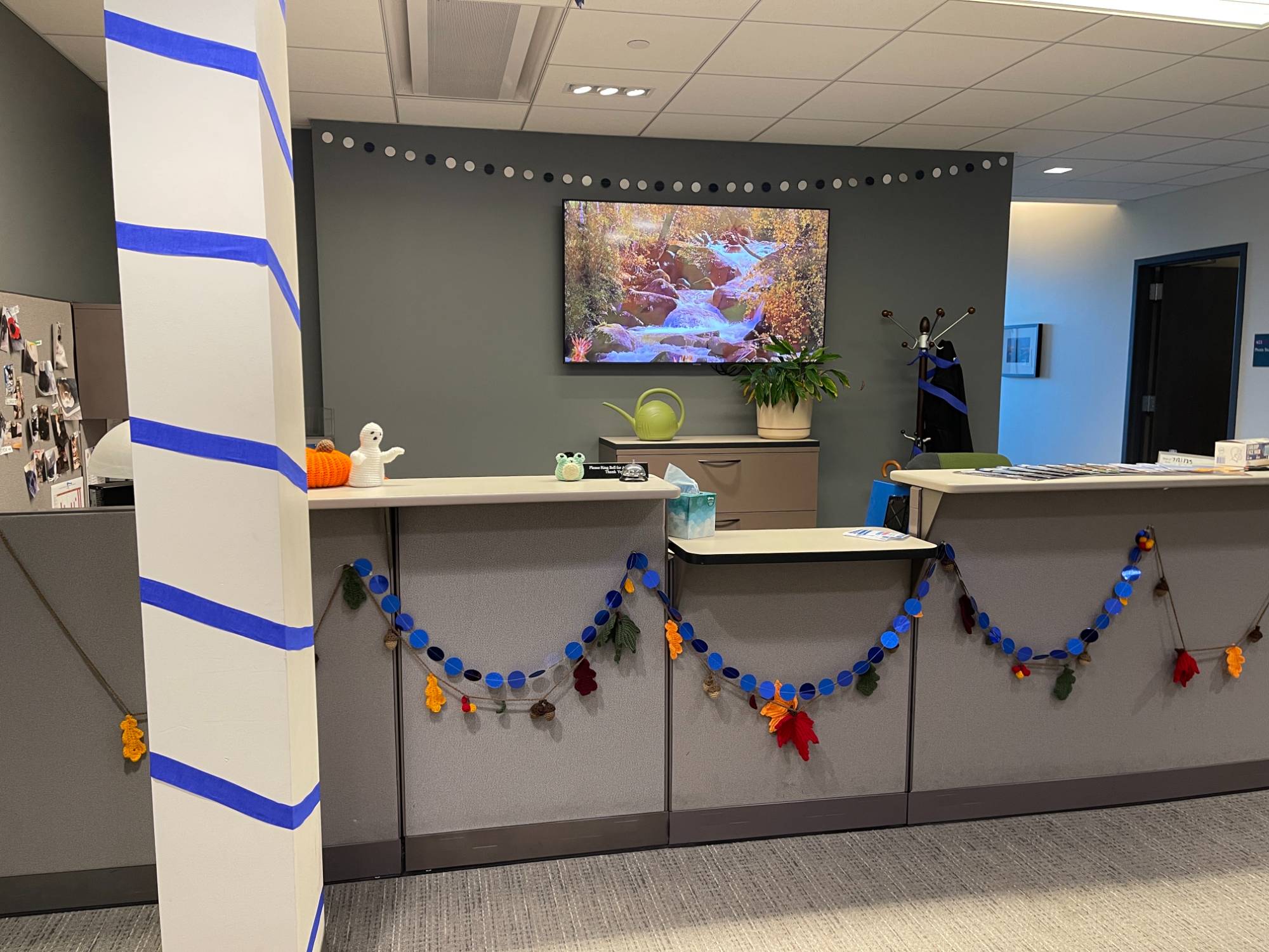 UComm Homecoming decorations, front desk with blue garland with leafs